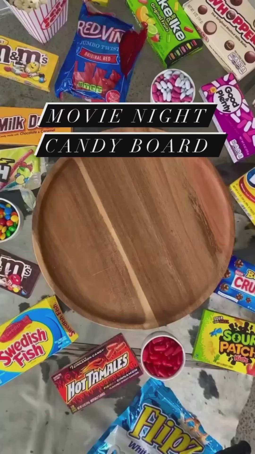 This may contain: the movie night candy board is surrounded by candies and other snacks on the floor