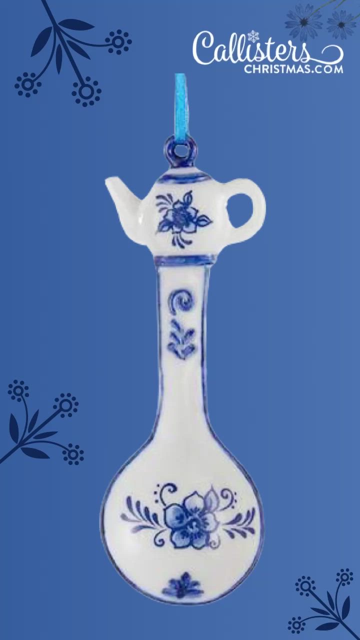 This may contain: a blue and white vase ornament with flowers on it