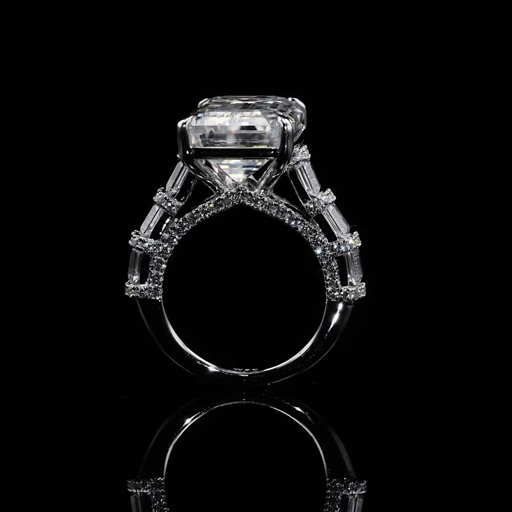 This may contain: a diamond engagement ring on a black background