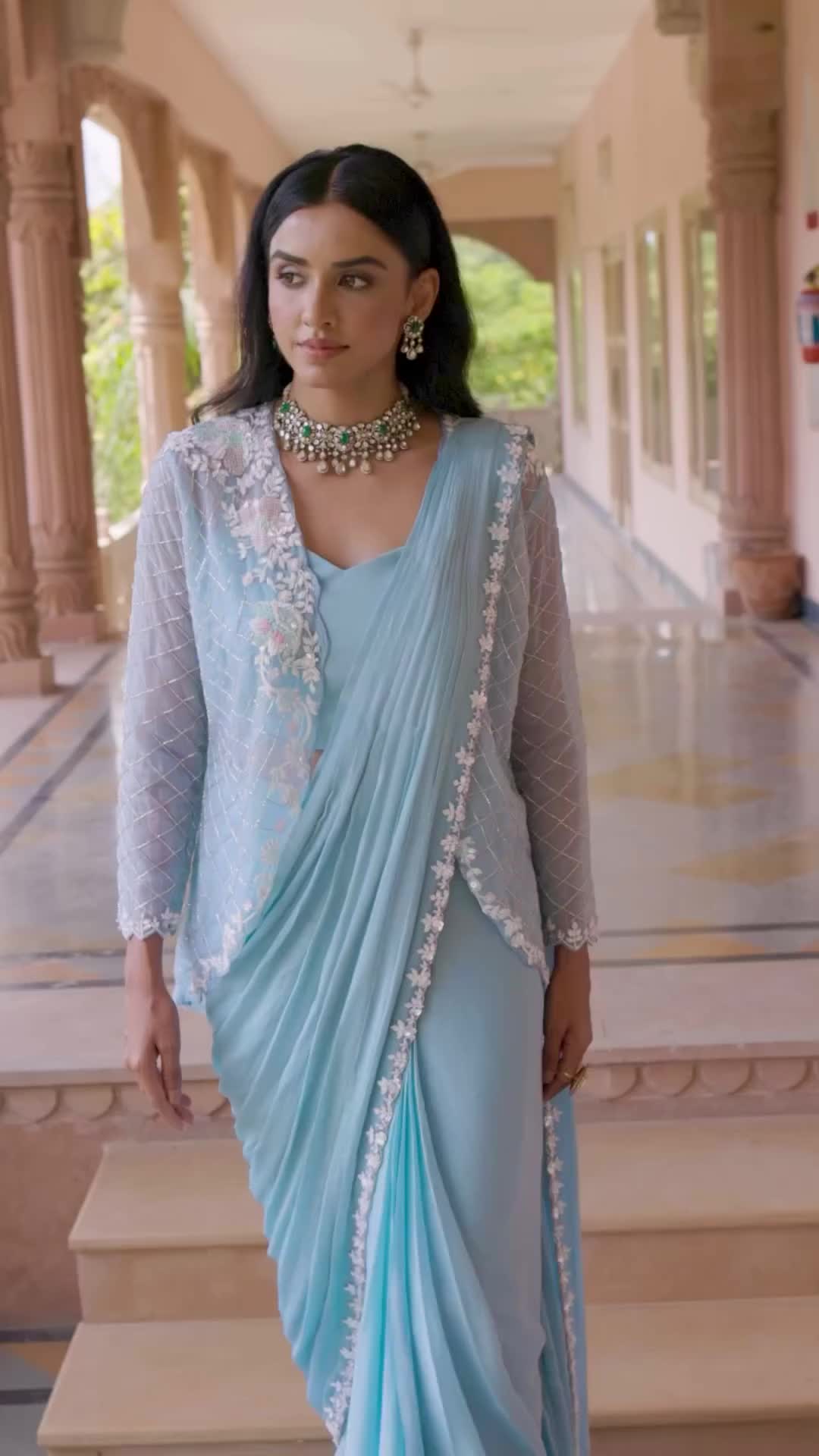 Embrace sophistication with this enchanting baby blue saree ensemble, featuring a graceful cape for added allure. Delicately adorned with intricate cut dana, moti, and sequins along the border, it’s a blend of classic charm and modern flair.  #aaritari #bridalwear #indianwear #indianclothing #bridalcollection #jaipur