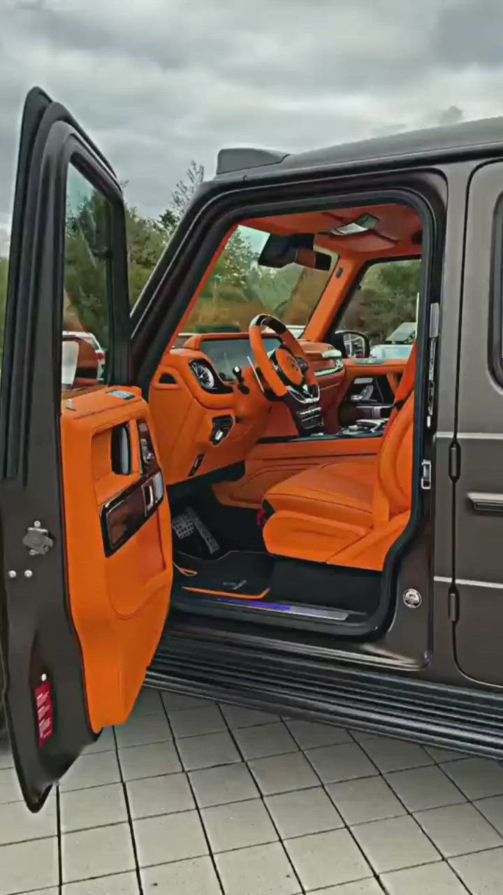 This may contain: the interior of an orange and black jeep with its doors open on a brick floor