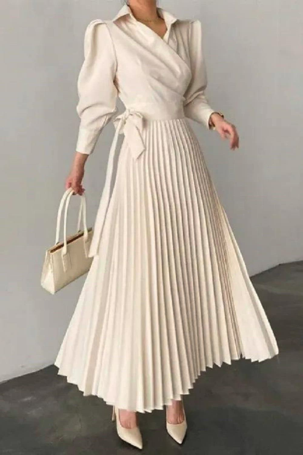 Indulge in modern elegance with our Pleated Asymmetric Solid Color Lapel Maxi Dress. The pleated design and asymmetric cut create a unique and sophisticated look, while the solid color adds a touch of simplicity. The lapel neckline enhances the overall chic appeal, making it a versatile choice for various occasions.