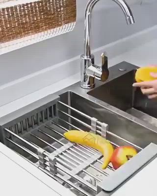 This may contain: a person washing fruit in a kitchen sink