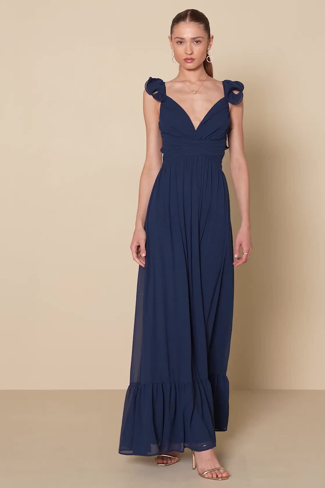 When the cocktails are poured and the music starts playing, you know it's time to slip into the Lulus Soiree Celebration Navy Blue Ruffled Lace-Up Maxi Dress Dress! Airy woven chiffon shapes this romantic gown that has short ruffled sleeves and a plunging V-neckline, with an open back accented by slender laces. Banded waist has a gathered, crossover design, above a sweeping skirt that falls to a maxi hem. Hidden zipper/clasp at back. Fit: This garment fits true to size. Length: Floor length. Size medium measures 56" from shoulder to hem. Bust: Great for any cup size. Waist: Fitted - very fitted at natural waist. Hip: Not Fitted - fuller skirt allows room for hips. Undergarments: May be worn with petals, or no bra. Fabric: Fabric has no stretch. Lined. Shell: 100% Polyester. Lining: 100% Po