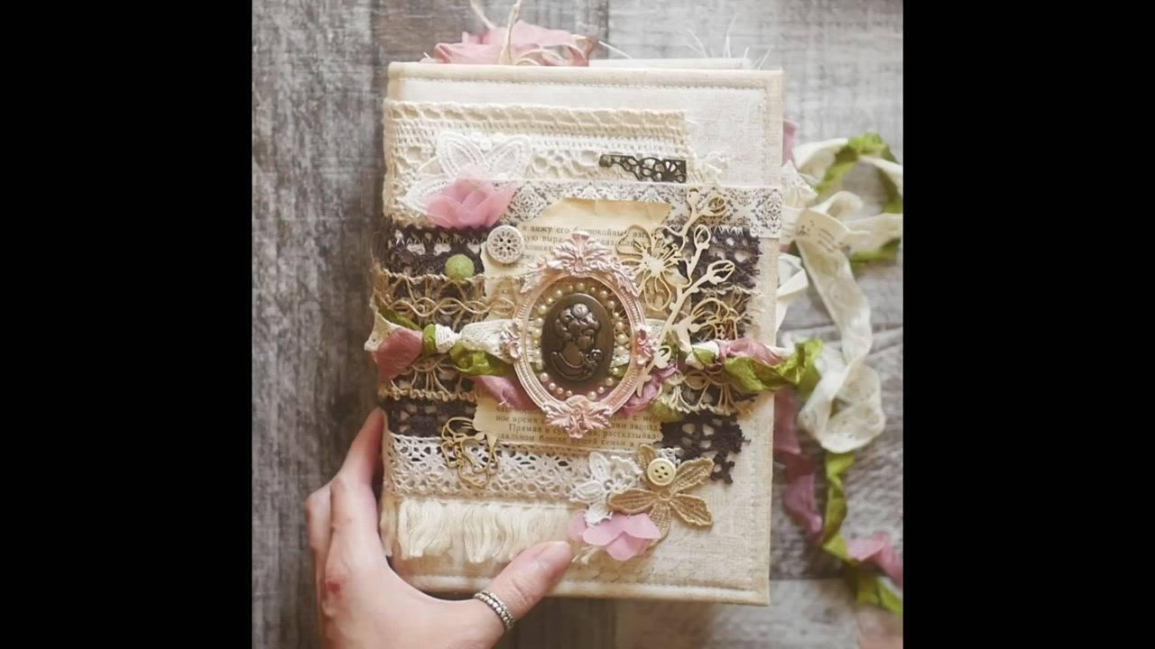 This may contain: a person holding an old book with the words vintage junk journal