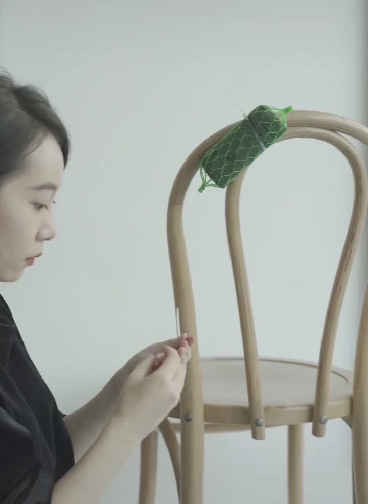 This may contain: a wooden chair with flowers and greenery on it