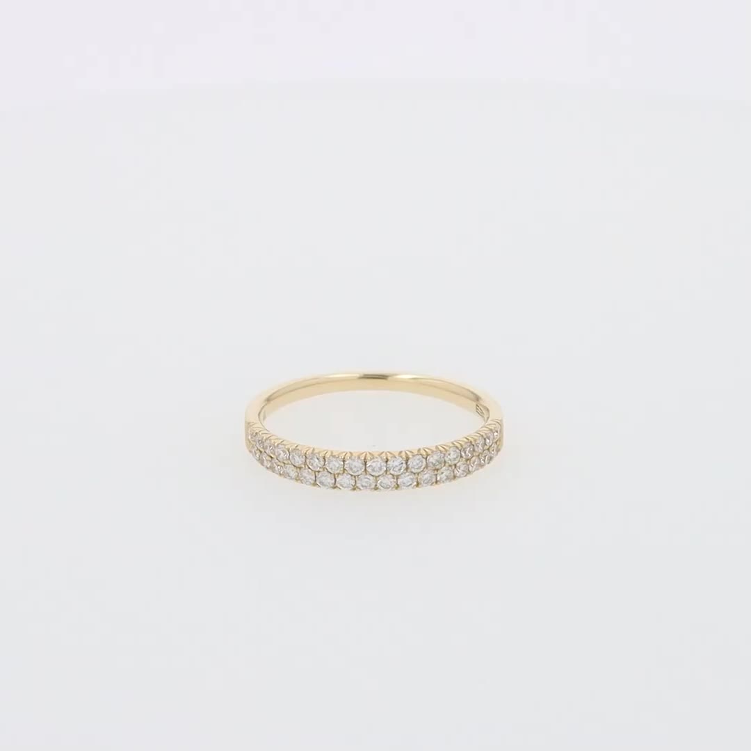 This may contain: a yellow gold ring with three rows of diamonds on the bottom, and one row of small