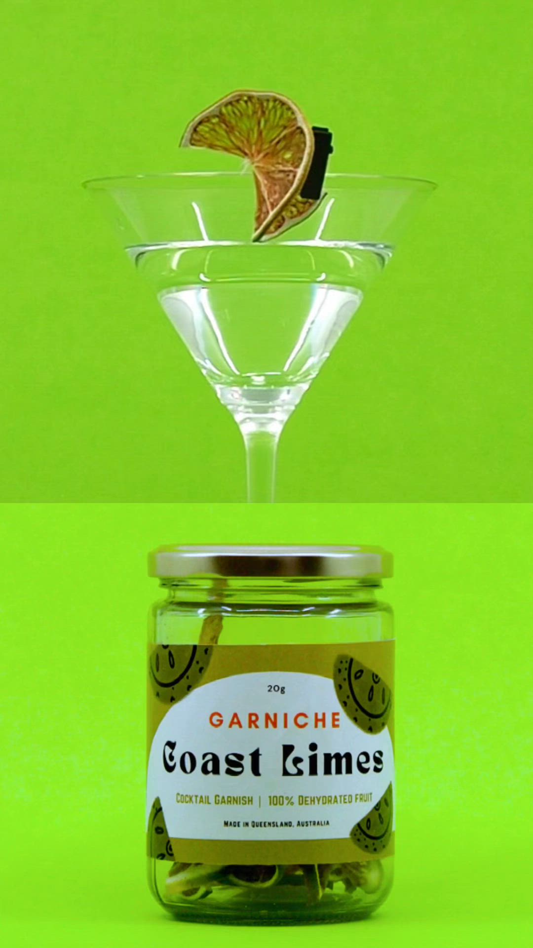 This may contain: a glass filled with green olives next to a jar of orange peels and a lemon wedge