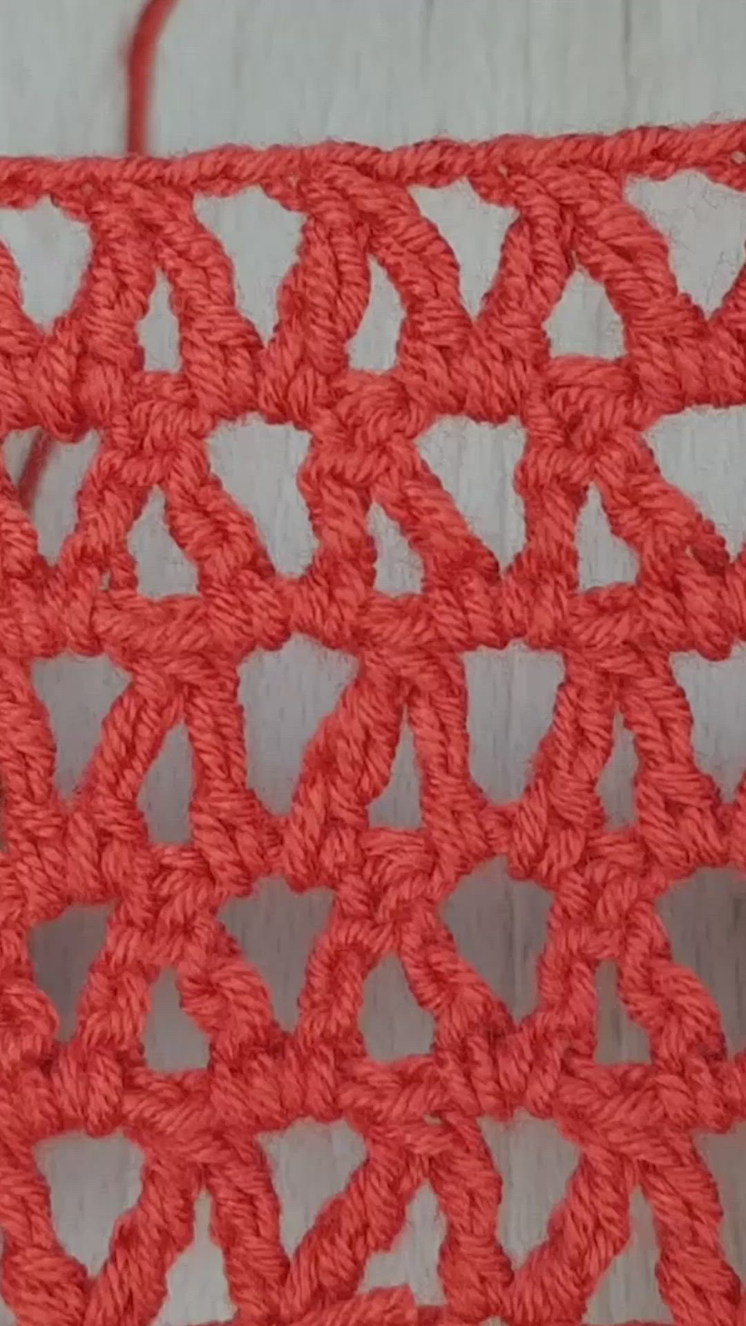 This may contain: an orange crochet pattern is shown