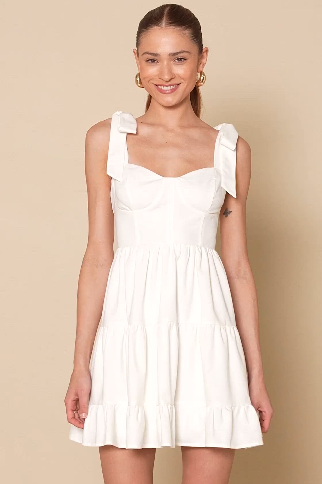 When you're looking to spread a little charm, we always suggest the Lulus Tier-ly Delightful White Tie-Strap Tiered Bustier Mini Dress! Lightweight, linen-blend woven fabric shapes this darling dress that has tying shoulder straps and a bustier-inspired bodice with hidden no-slip strips. Fitted waist tops a tiered skirt that falls to an adorable mini hem. Hidden zipper/clasp at back. Fit: This garment fits true to size. Length: Mid-thigh. Size medium measures 25.75" from adjustable straps to hem