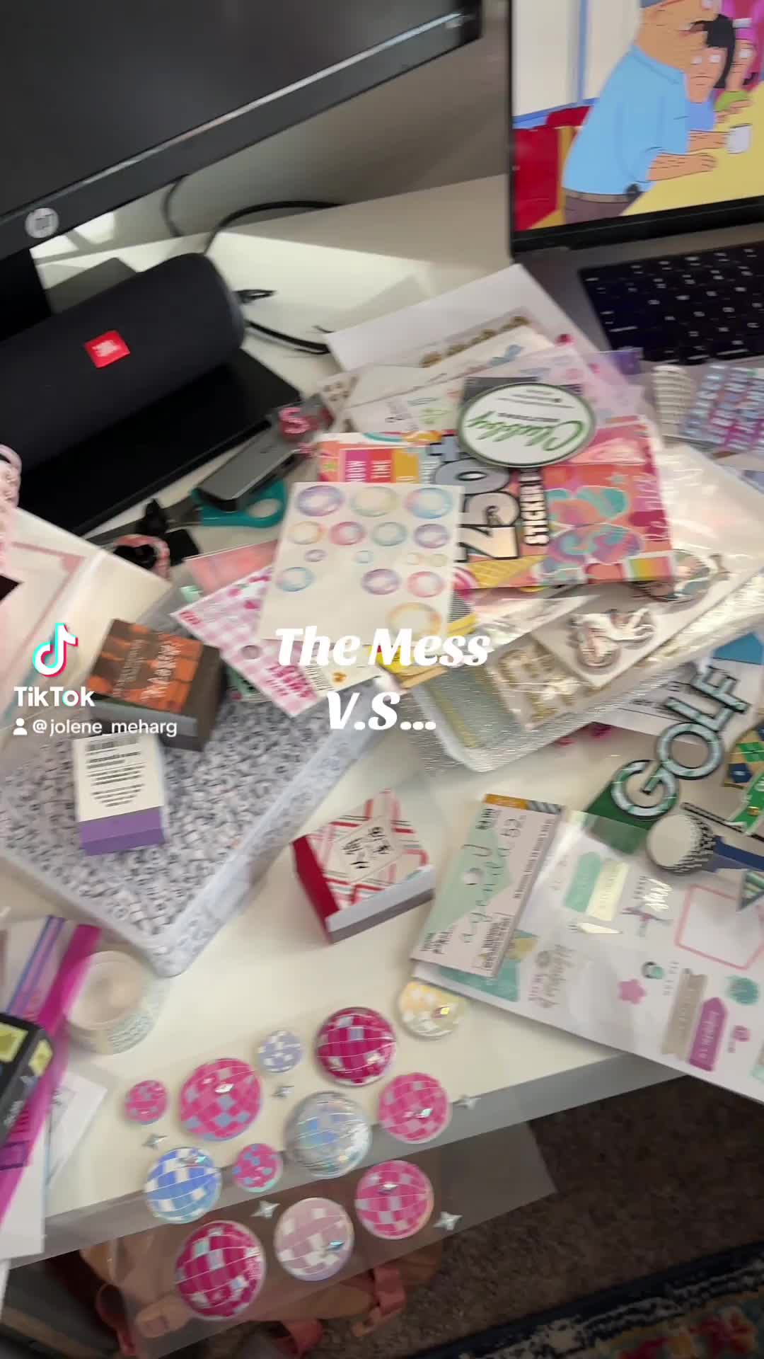 This may contain: many different items are on the table next to a computer monitor and keyboard, which is also covered in stickers