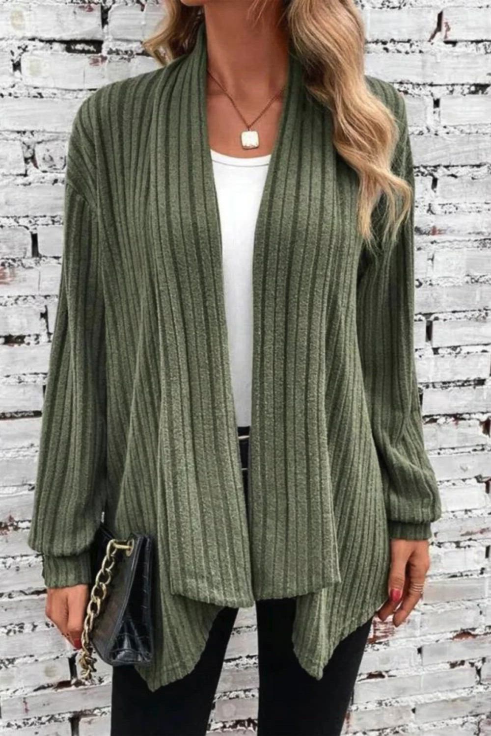 Elevate your wardrobe with our Irregular Neckline Ribbed Knitted Cardigan. The unique neckline adds a modern touch to this classic piece. Crafted with ribbed knit for texture and comfort, it's perfect for layering in style.