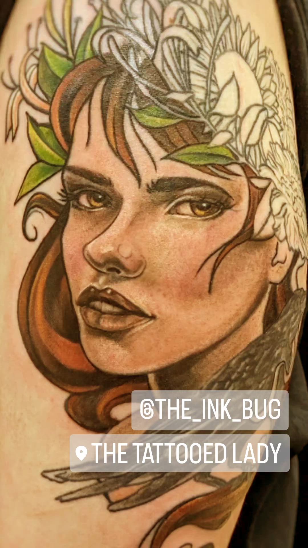 This may contain: a woman's face with flowers and leaves on her head is shown in this tattoo design