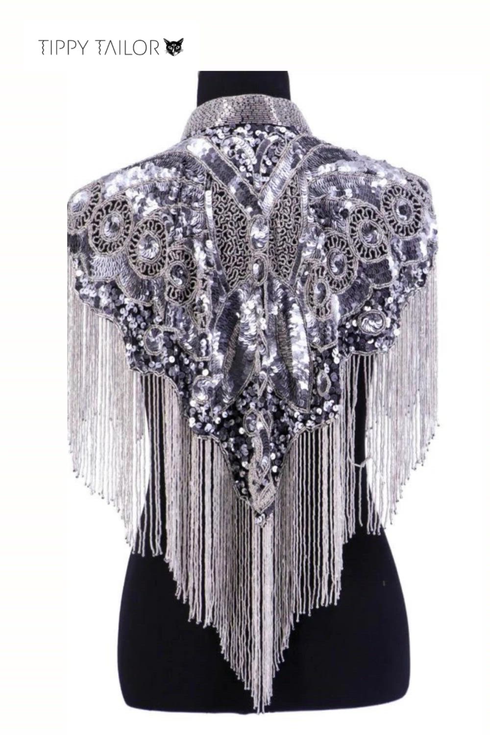 This contains: a black and white shawl with silver sequins