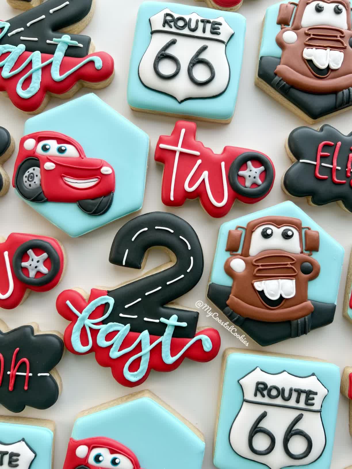 This may contain: decorated cookies are arranged in the shape of cars and highway signs, along with numbers that spell out route 66