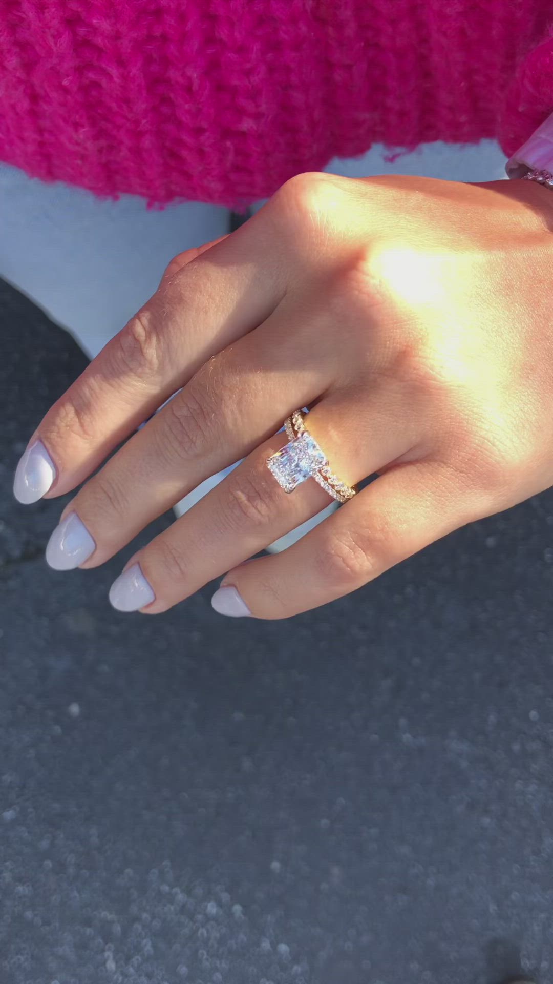 This may contain: a close up of a person's hand with a diamond ring on their finger