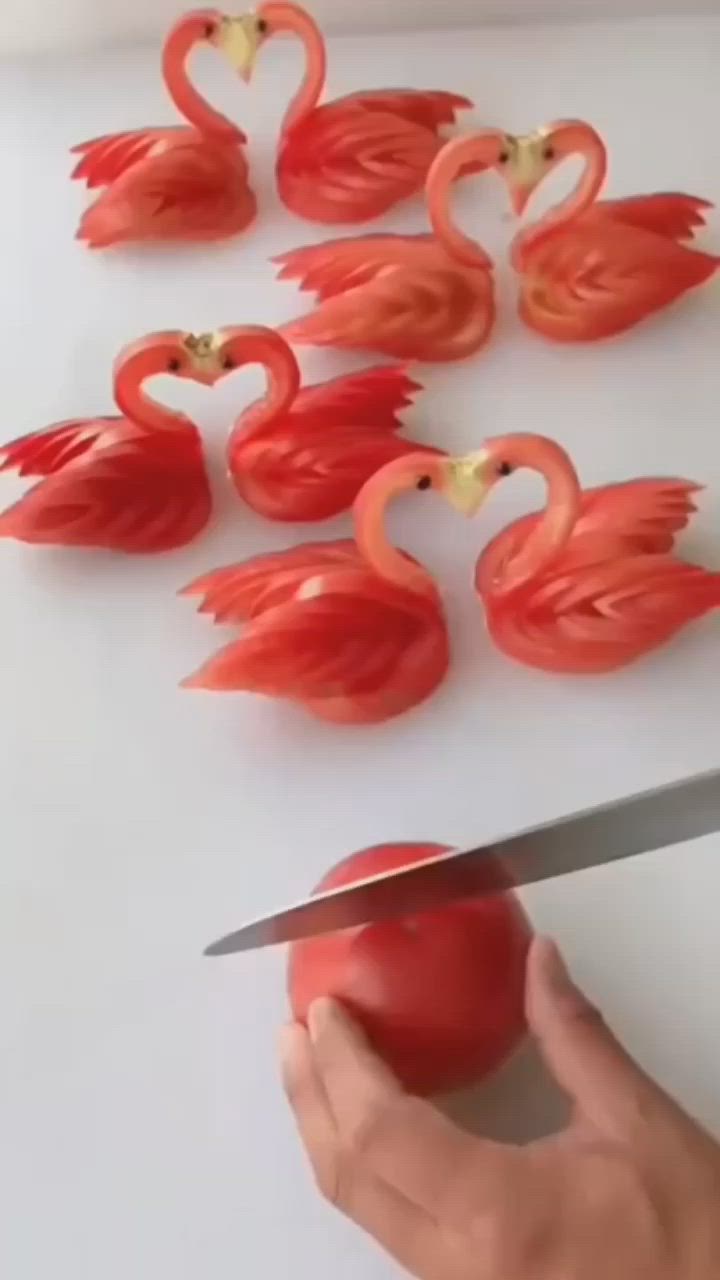 This may contain: a person is cutting tomatoes into small flamingos