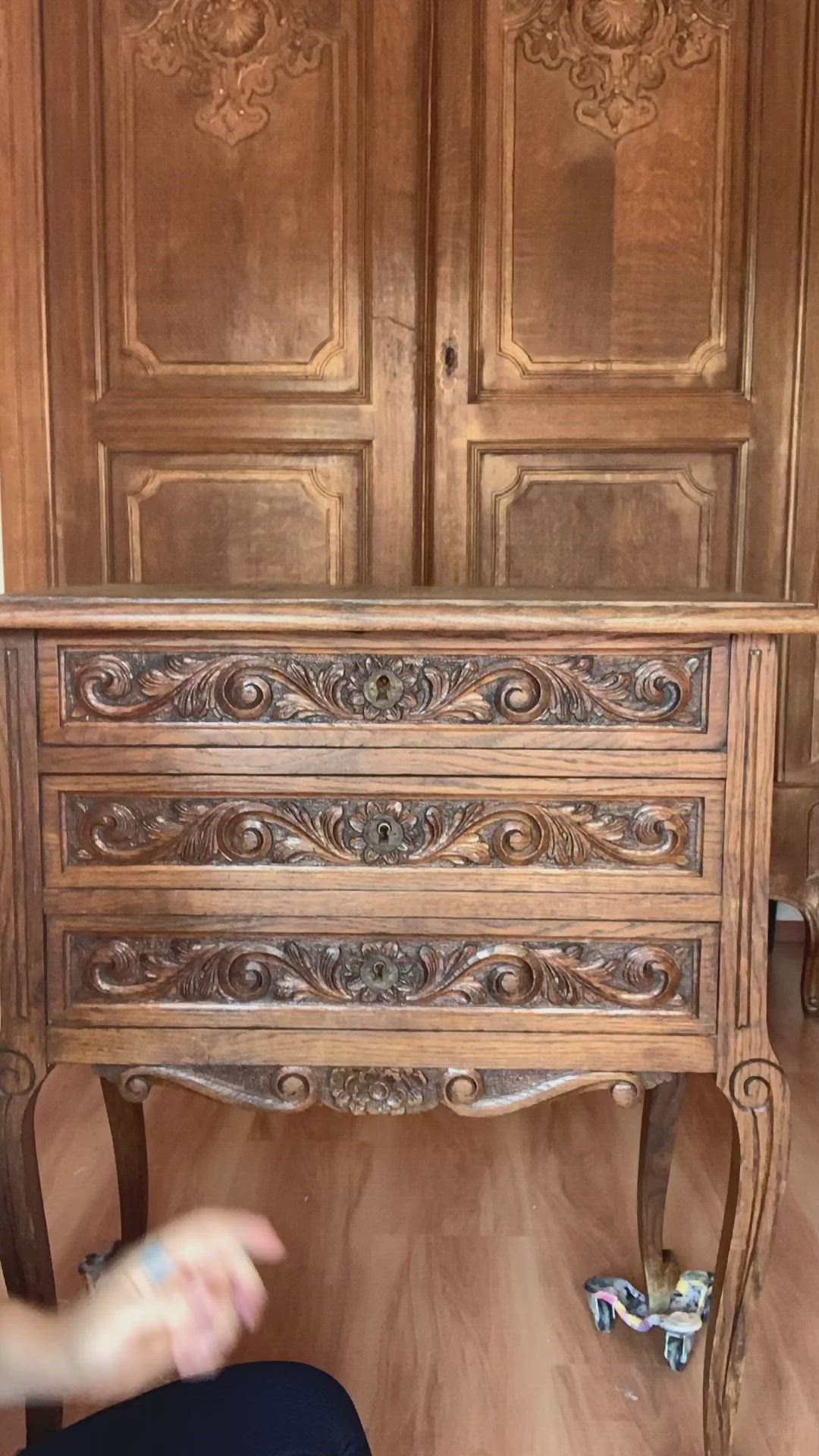 This may contain: an old wooden dresser with ornate carvings on it