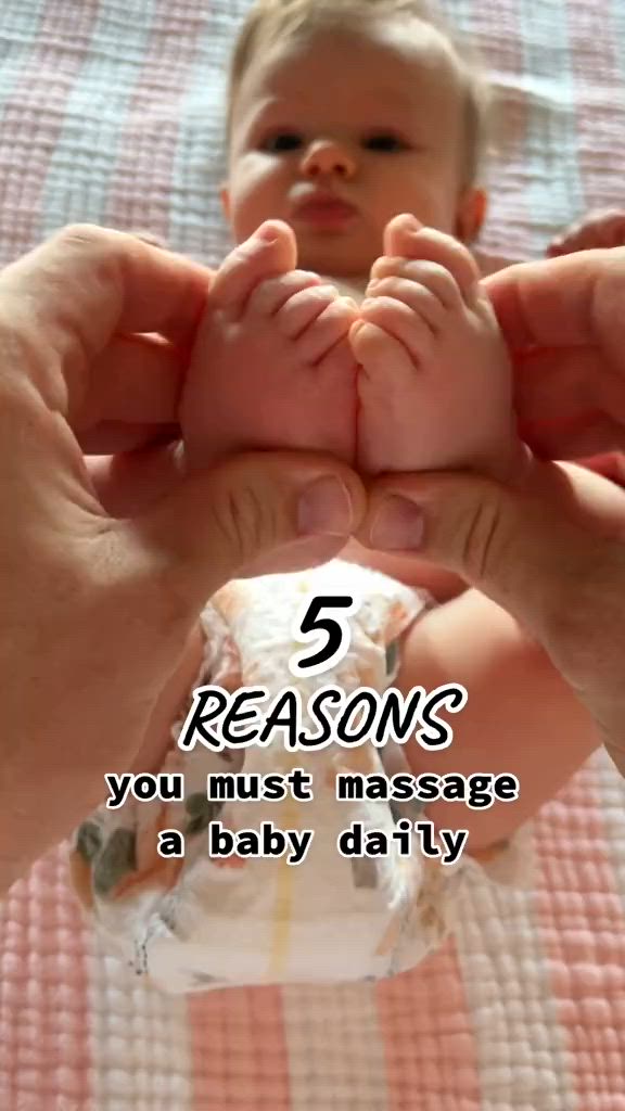 This may contain: a person holding a baby in their hands with the words, 5 reason you must massage a baby daily