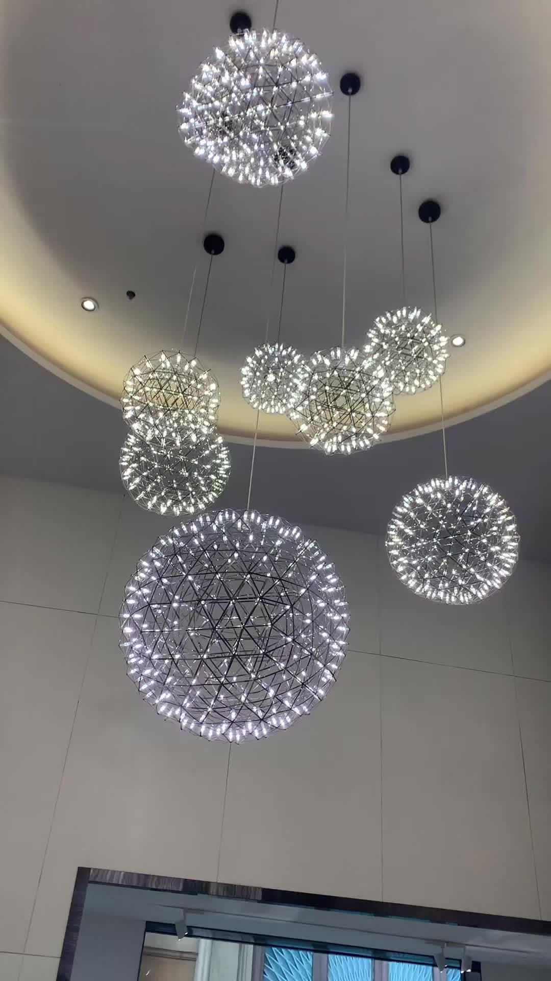 This may contain: several circular lights hanging from the ceiling in a room with white walls and flooring