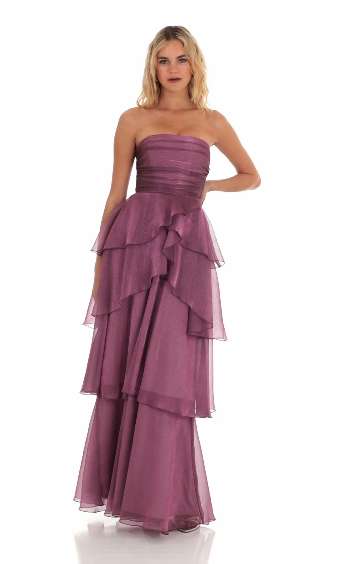 This may contain: a woman in a strapless purple dress