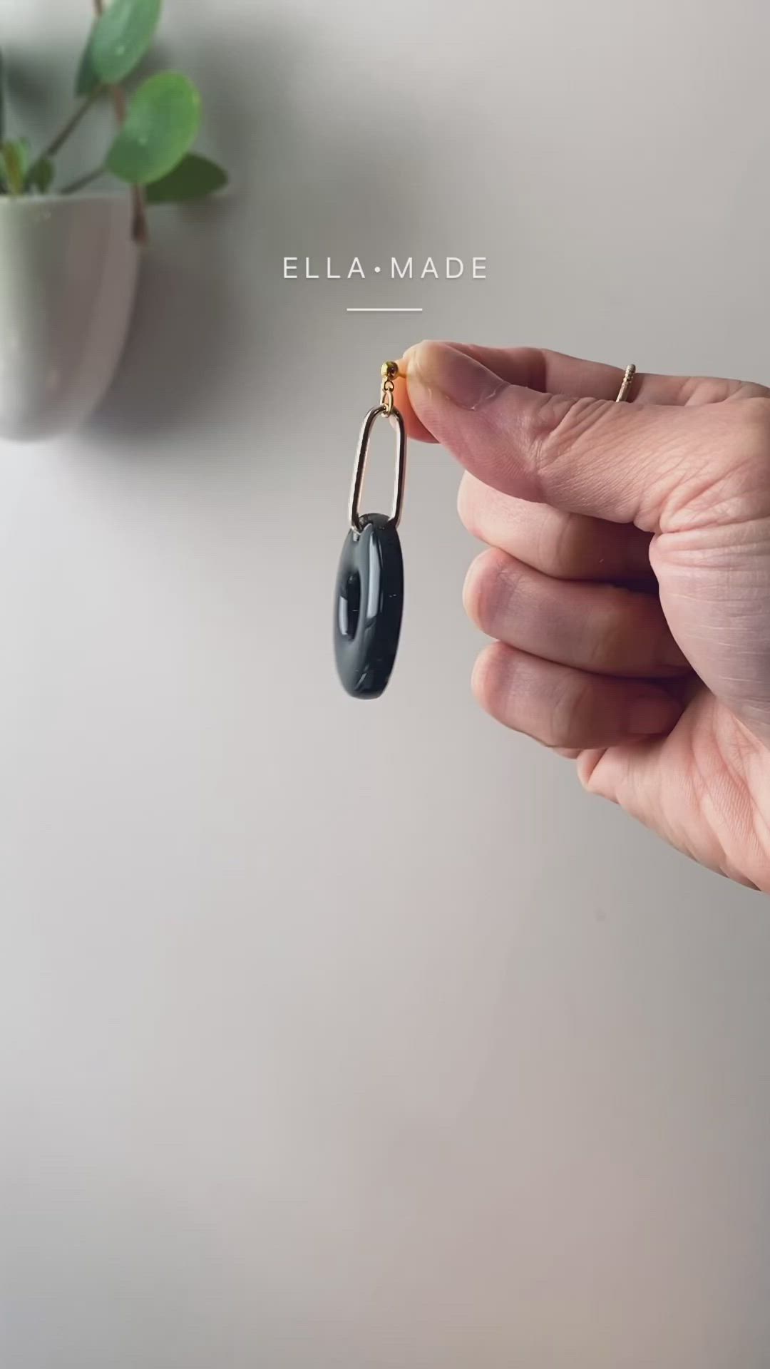 This contains an image of: Modern chunky black earrings, donut shape drop earrings, black outfit, stationery accessories