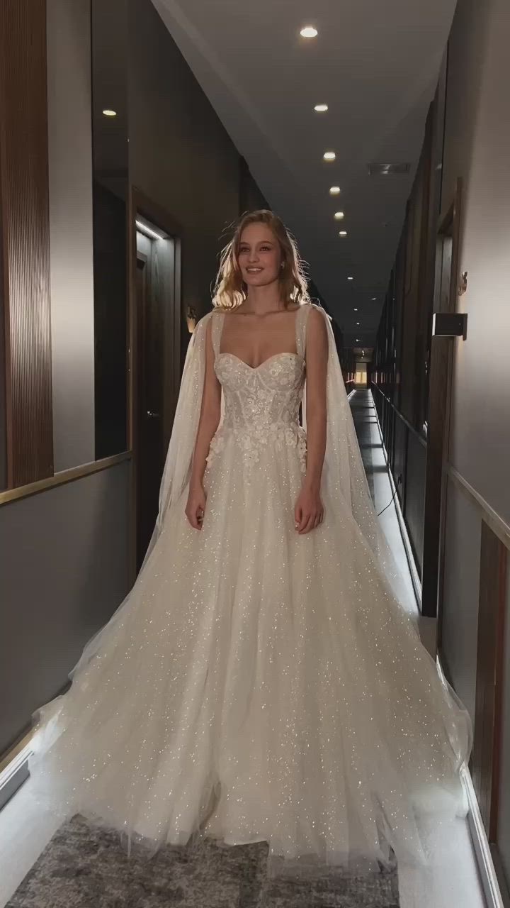 This may contain: a woman in a wedding dress is standing on the hallway with her veil over her head