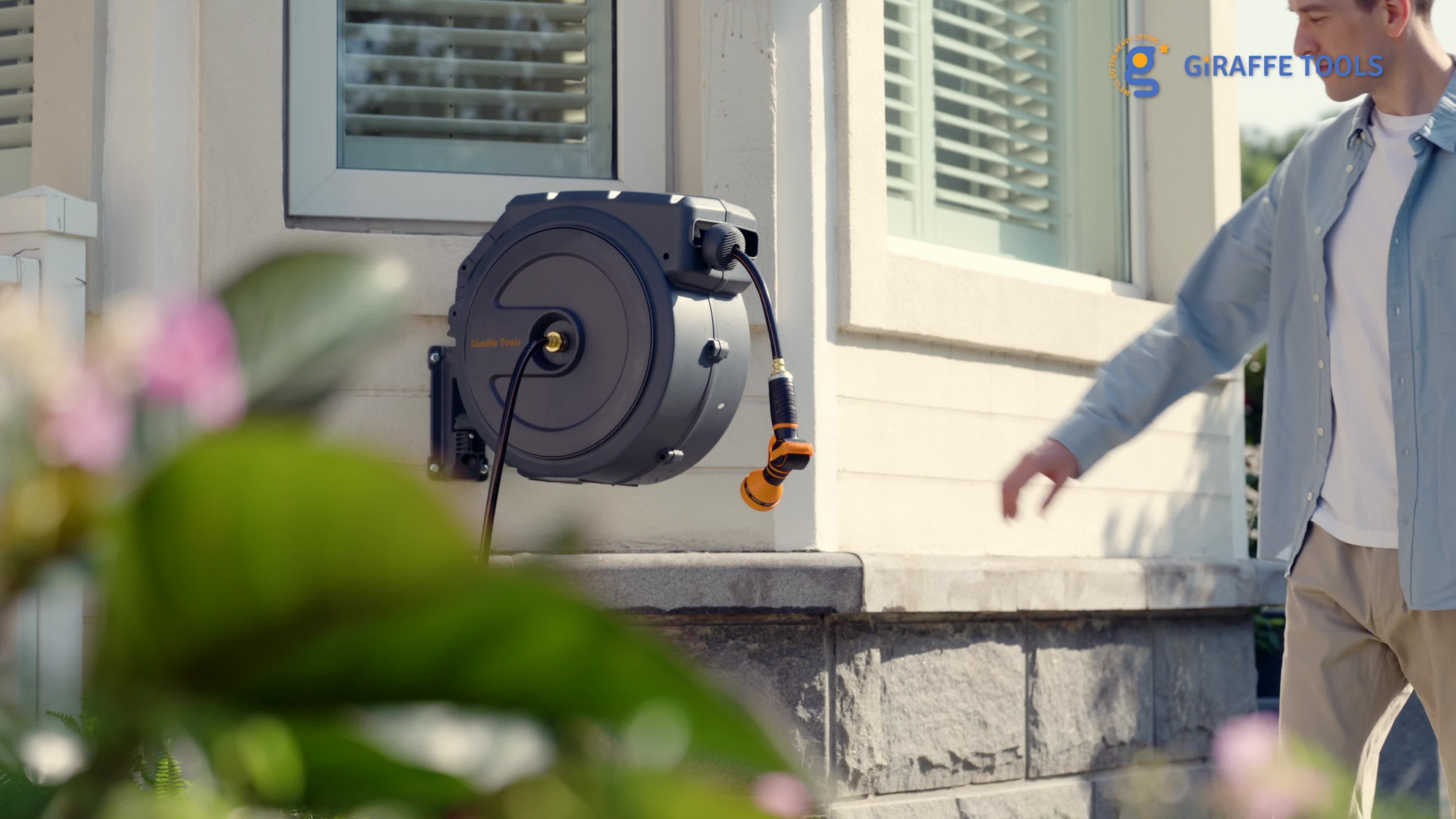 This may contain: a man is talking on his cell phone while walking by a house with shutters