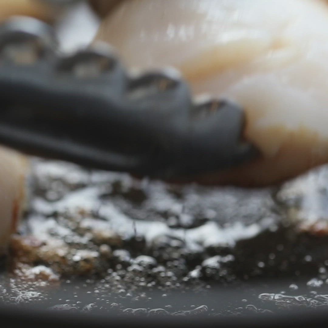 This may contain: lemon butter scallops on a pan with the words lemon butter scallops