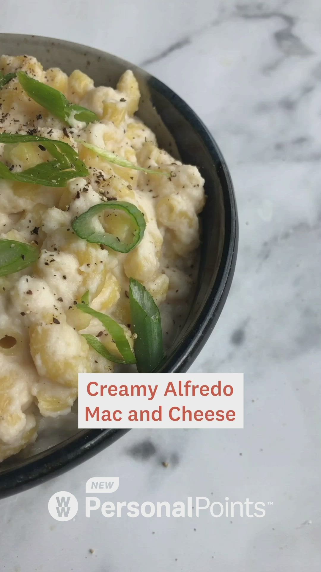 This may contain: a bowl filled with macaroni and cheese on top of a table