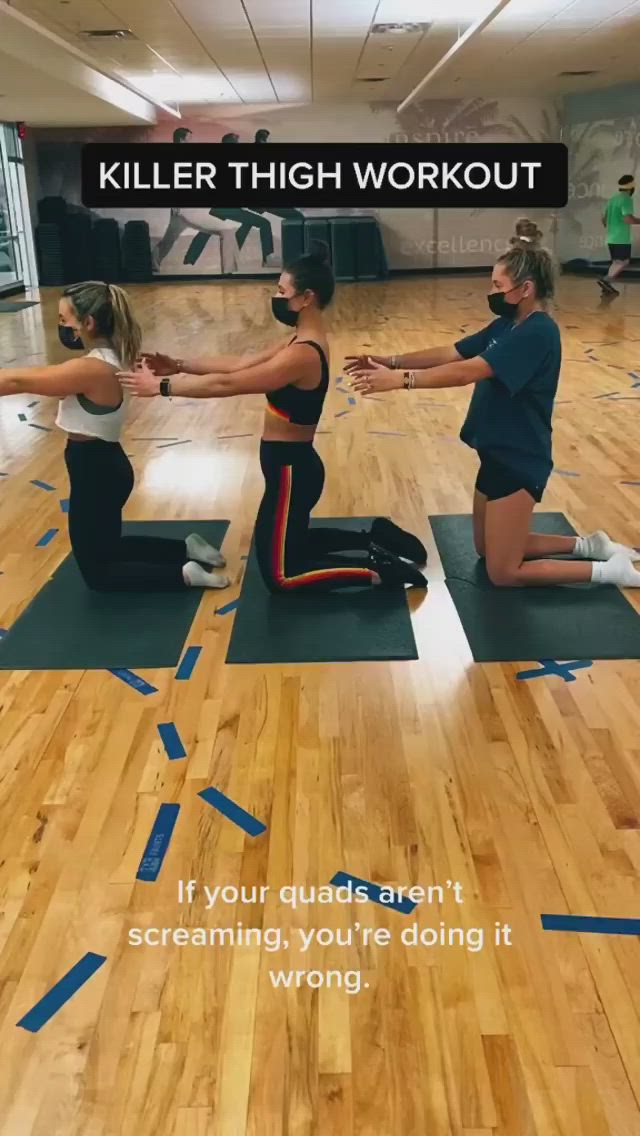 This may contain: two women are doing yoga on mats in an empty room with the caption killer high workout if your muscles aren't screaming, you're doing it wrong