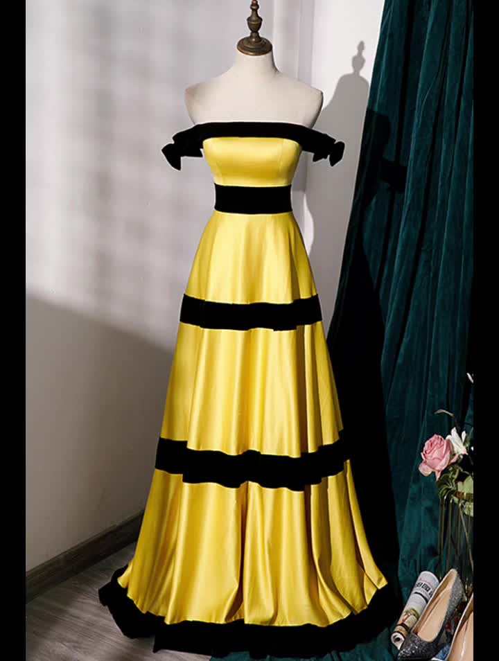 This contains: Black And Yellow Striped Aline Long Formal Dress. This statement piece is perfect for a formal event where you want to stand out. The classic A-line silhouette flatters all body types, and the black and yellow color combination is eye-catching and fun.