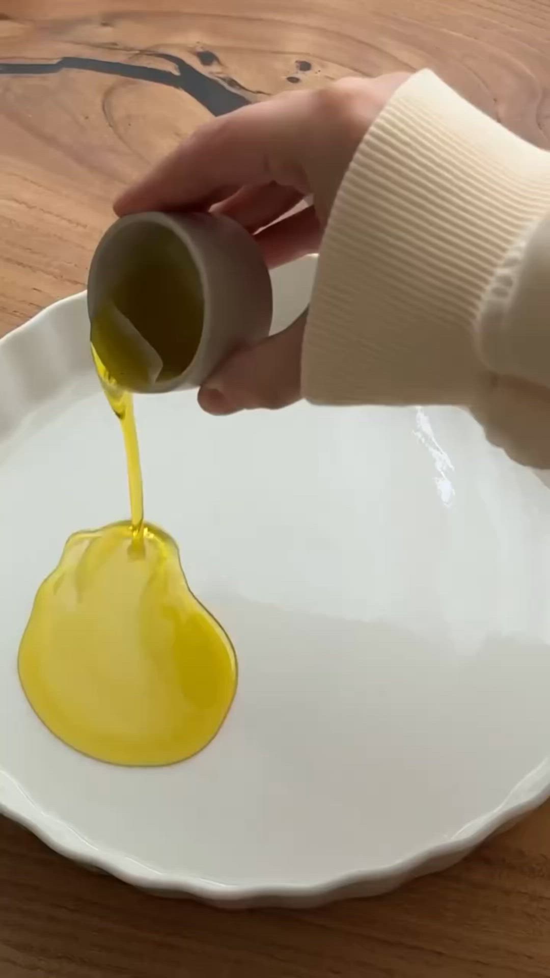 This may contain: someone is pouring mustard into a white plate