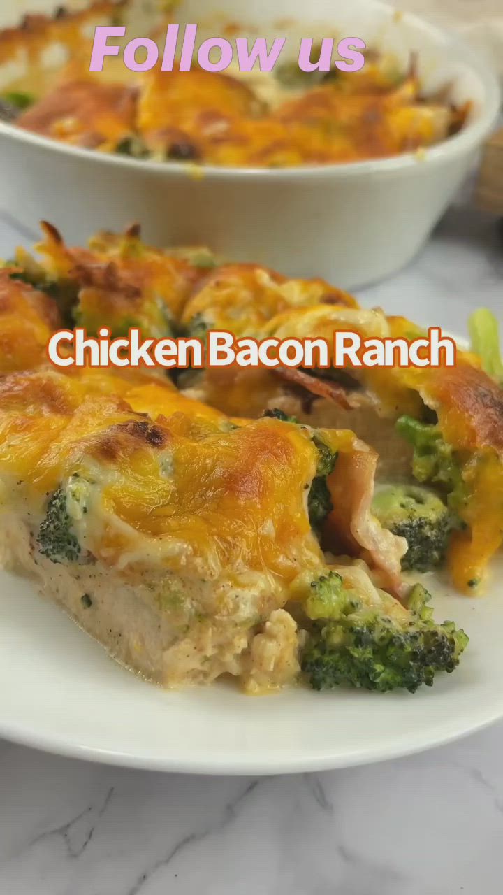 This may contain: chicken bacon ranch casserole with broccoli and cheese on the side, sitting on a white plate