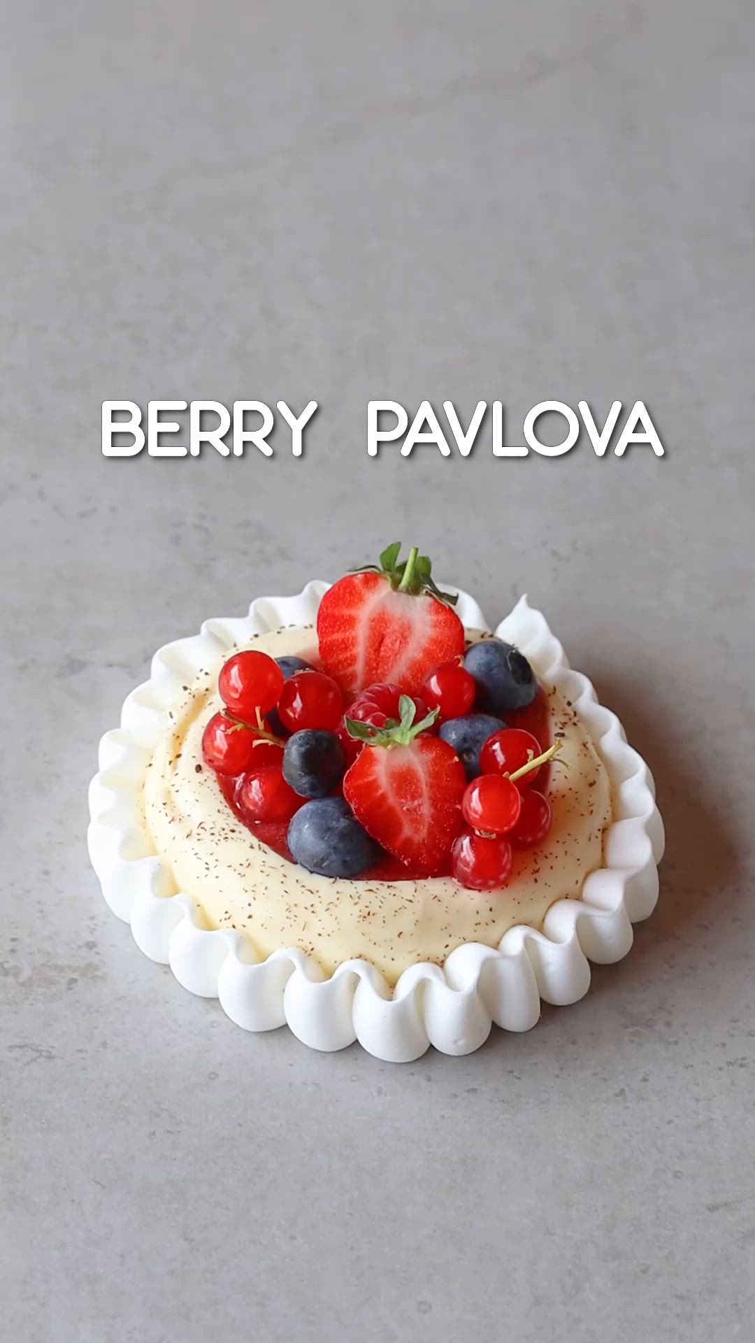 This may contain: there is a cake with berries on top and the words berry pavoa above it