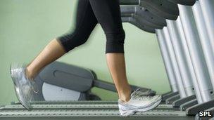 Woman running on treadmill in gym