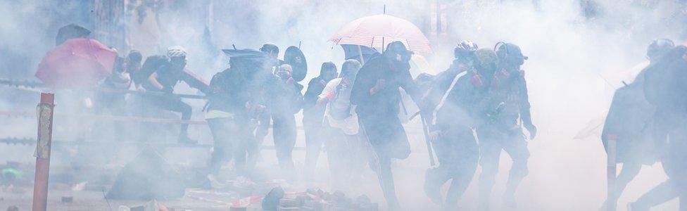 Protesters amid tear gas during the Hong Kong Polytechnic University demonstration