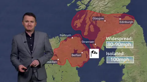 Weather forecaster Matt Taylor stands in front of a virtual map showing the red weather warnings in place across parts of Northern Ireland and Scotland