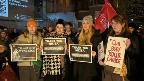 Demonstrators in Dublin holding signs thanking Nikita Hand