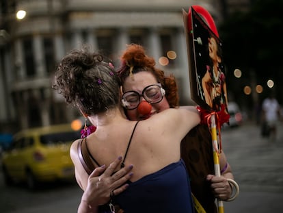 Artists hug during a protest against the death of Venezuelan artist Julieta Hernández and violence against women, in Rio de Janeiro, Brazil, Friday, Jan. 12, 2024. The body of Hernández, who had been missing since Dec. 23 while traveling by bicycle, was found by the police in the backyard of the home of the couple accused of killing her. (AP Photo/Bruna Prado)