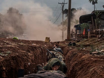 Karenni soldiers take shelter inside a drainage ditch as a mortar shell explodes close by during heavy clashes on April 16, 2023, in the village of Daw Nyay Khu, in Kayah (Karenni) State, eastern Myanmar (Burma). Two years after Myanmar plunged into civil war, the country’s military has increasingly taken drastic measures to destroy the uprising–with a heavy toll on the civilian population. In April this year, an airstrike by the junta killed 168 men, women and children. Last year the military struck a school with attack helicopters, killing several children. In the same month, an aerial bombing of a concert killed about 50 people.