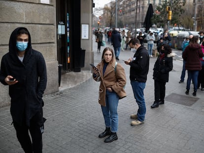 Decenas de personas hacen cola para someterse a pruebas de antígenos o PCR para la detección de la covid-19 en un laboratorio de Barcelona.