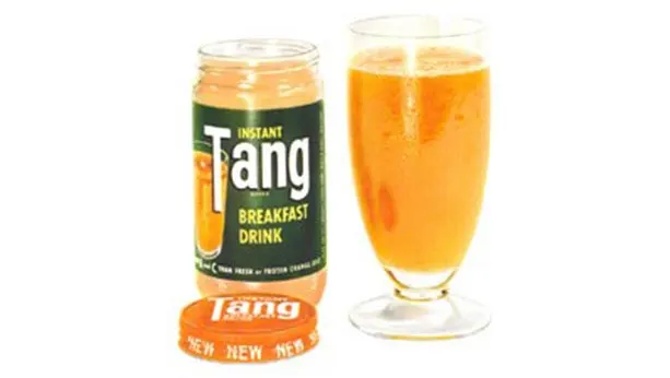 Tang jar from 1957 with a glass full of tang next to it.