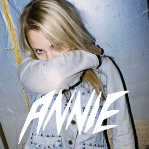 The cover of Anniemal featuring the word Annie at the bottom and showing Annie, a twentysomething blonde woman, with her arm covering her mouth