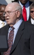 Photograph of Ryan wearing a dark pinstripe shirt