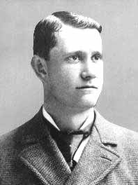 Black-and-white photo of Ed Delahanty in a suit, facing right