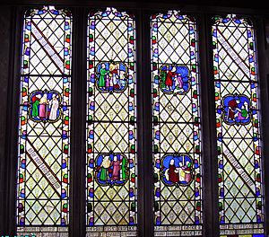 Photo of colourful stained class window showing human figures