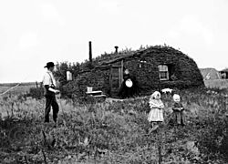 Settlers in front of their sod house in Milton in 1898.