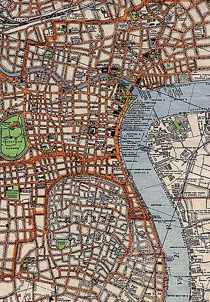 A map showing a river coming up from the bottom right and curving toward the right about two-thirds of the way up where another, smaller river joins from the left. On the left of the river is a complex network of streets with some parks; on the right are some property lines.