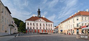 Tartu Town Hall and square, three story stone building with red hip roof